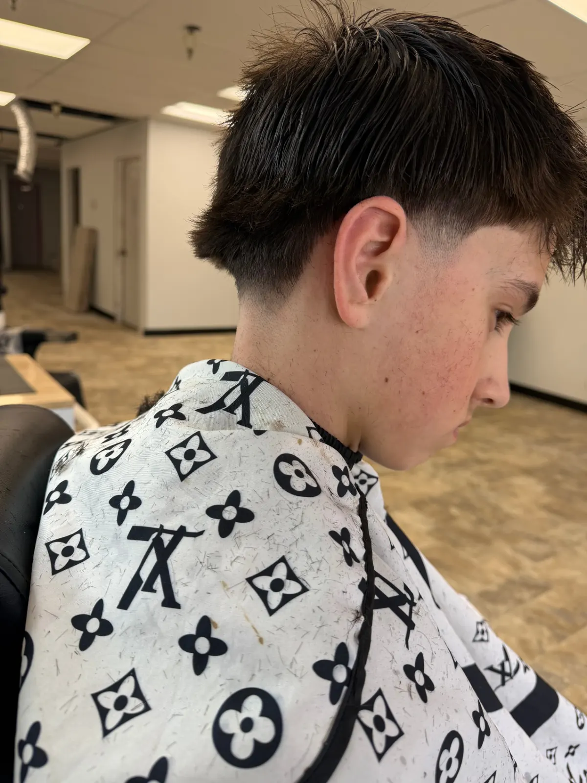 Textured crop with a low taper fade by our barbers