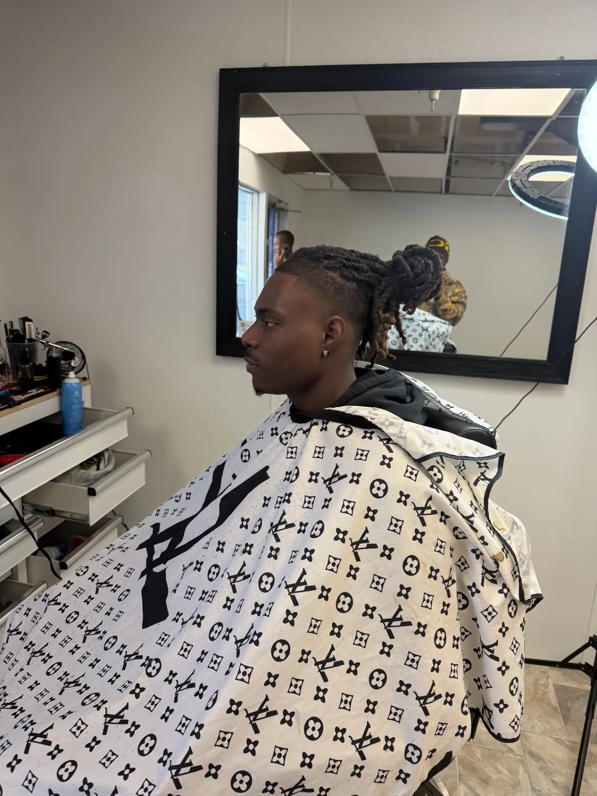 Locs styled up with a fresh fade on the sides